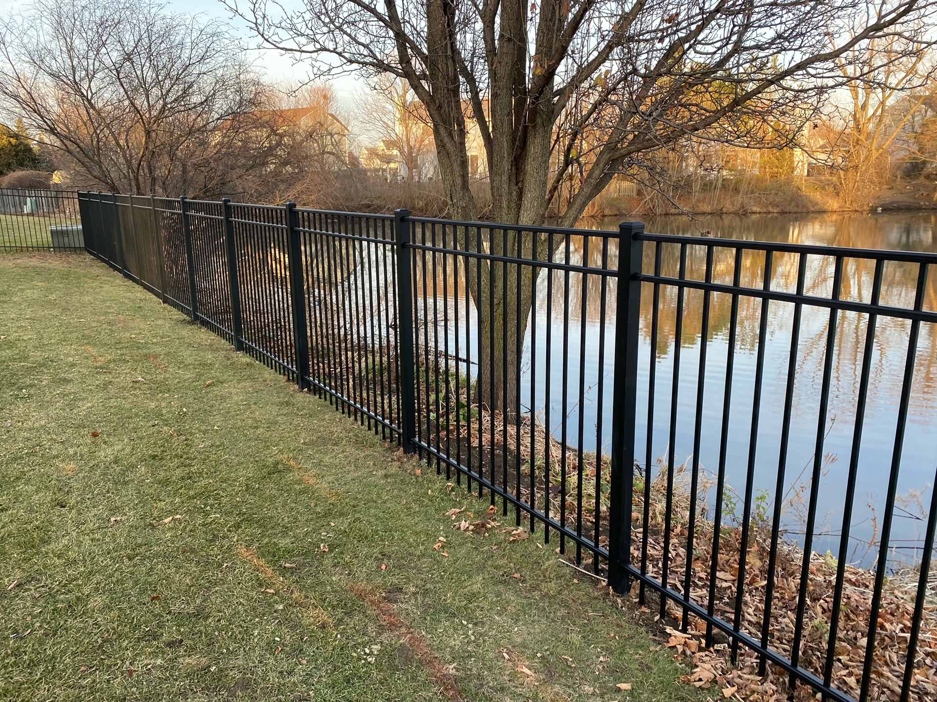 Wrought iron fence installed along pond