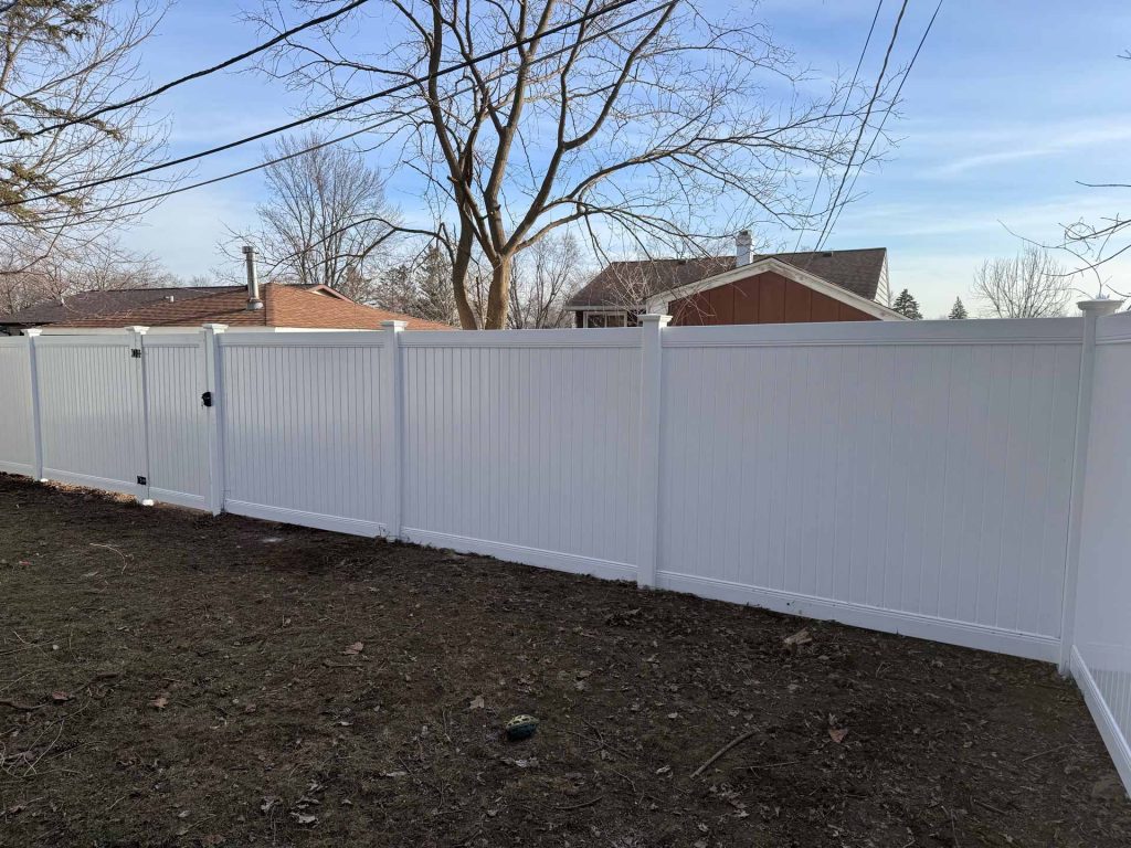 Vinyl privacy fence installed in backyard